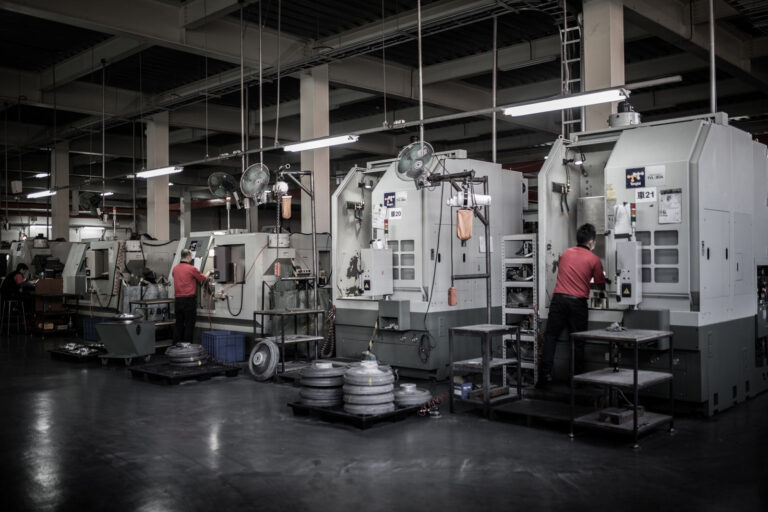 Workers operating lathe machines