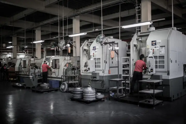 Workers operating lathe machines