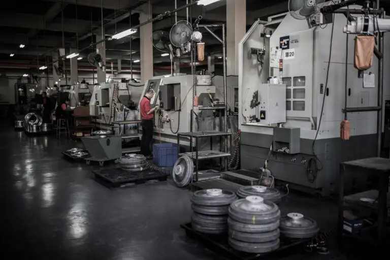Detail of worker operating lathe machine