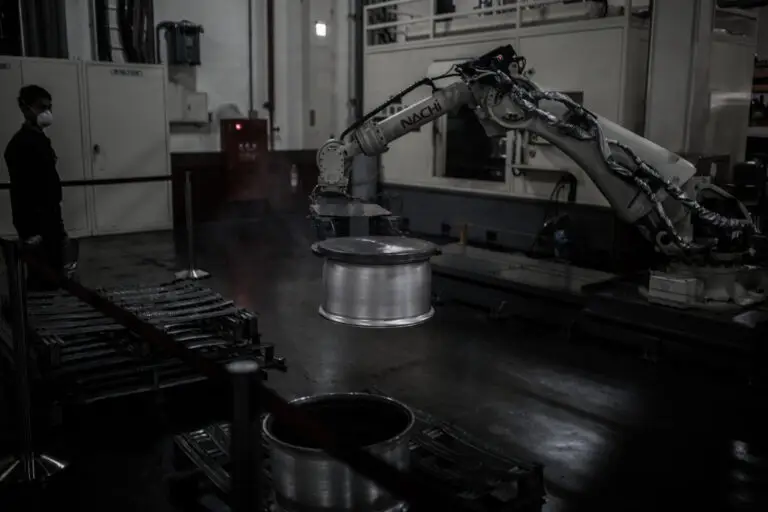 Robotic arm moving the forging to the next area
