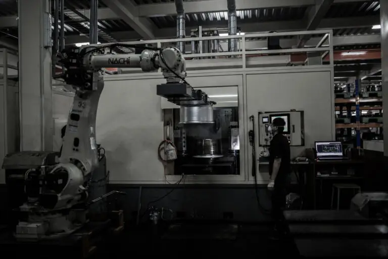 Robotic arm removing the forging from the lathe