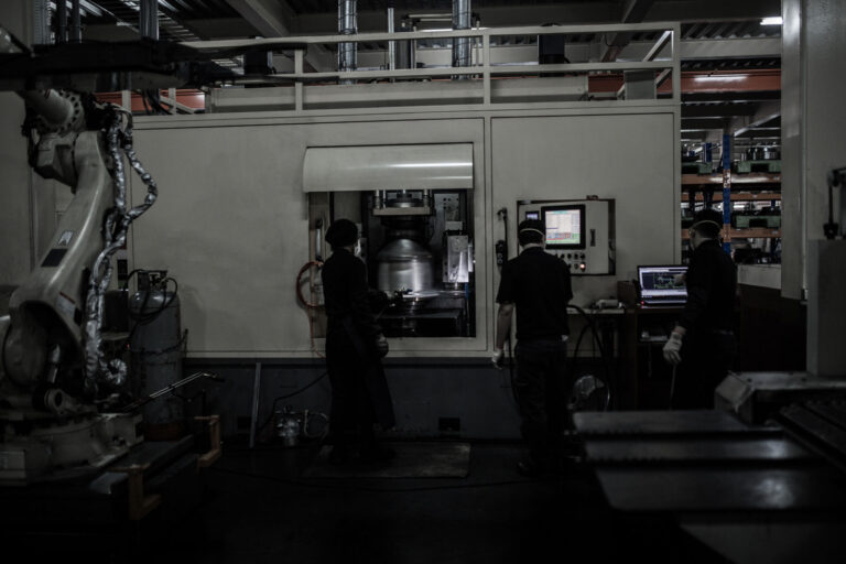 Machinists operating the lathe