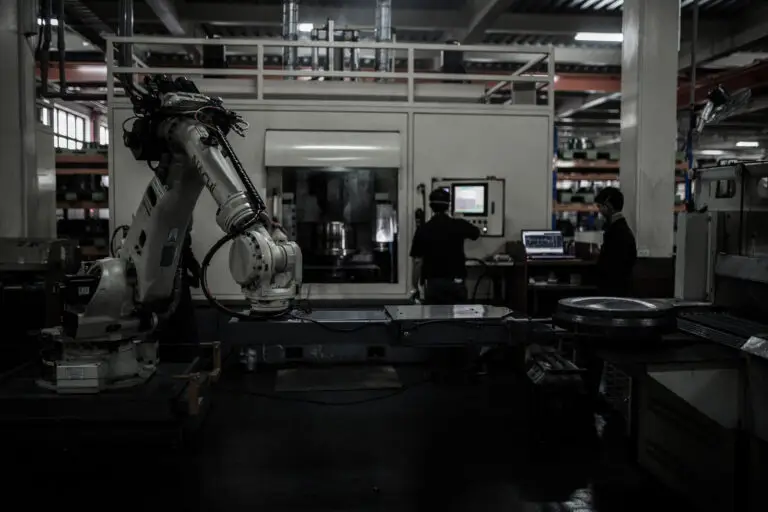 Robotic arm grabbing forging from the oven
