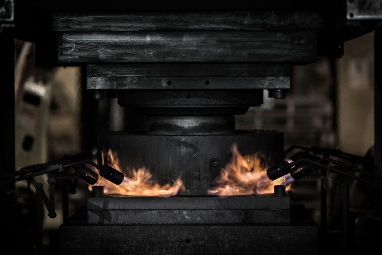 Forging press heating and pressing aluminum barstock detail