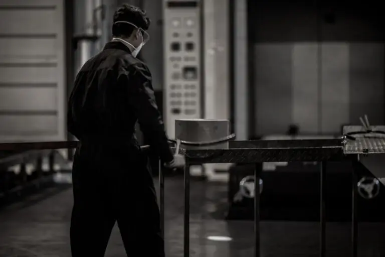 Worker handling smaller aluminum barstock